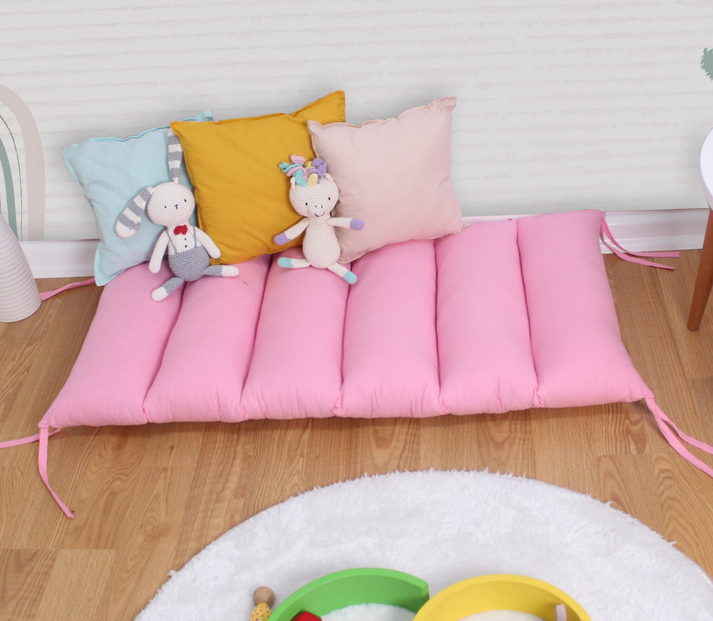a child's play area with toys and pillows