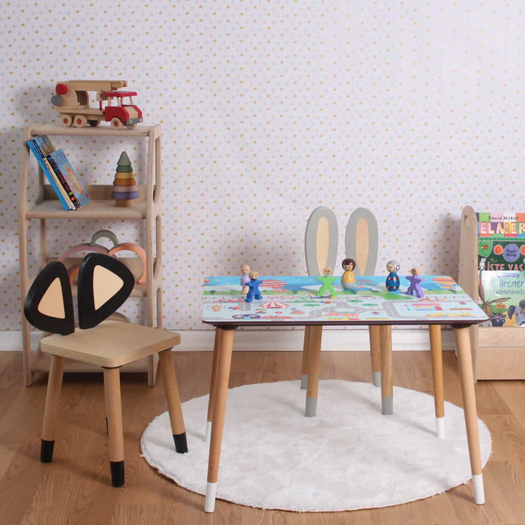 a child's table and chairs in a room