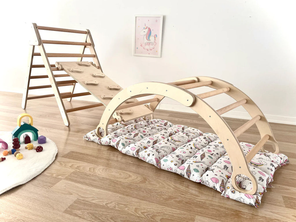 a child's bed with a slide and a play mat