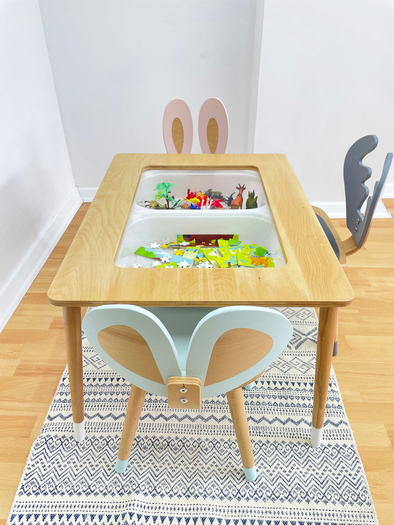 a child's table and chair with a painting on it