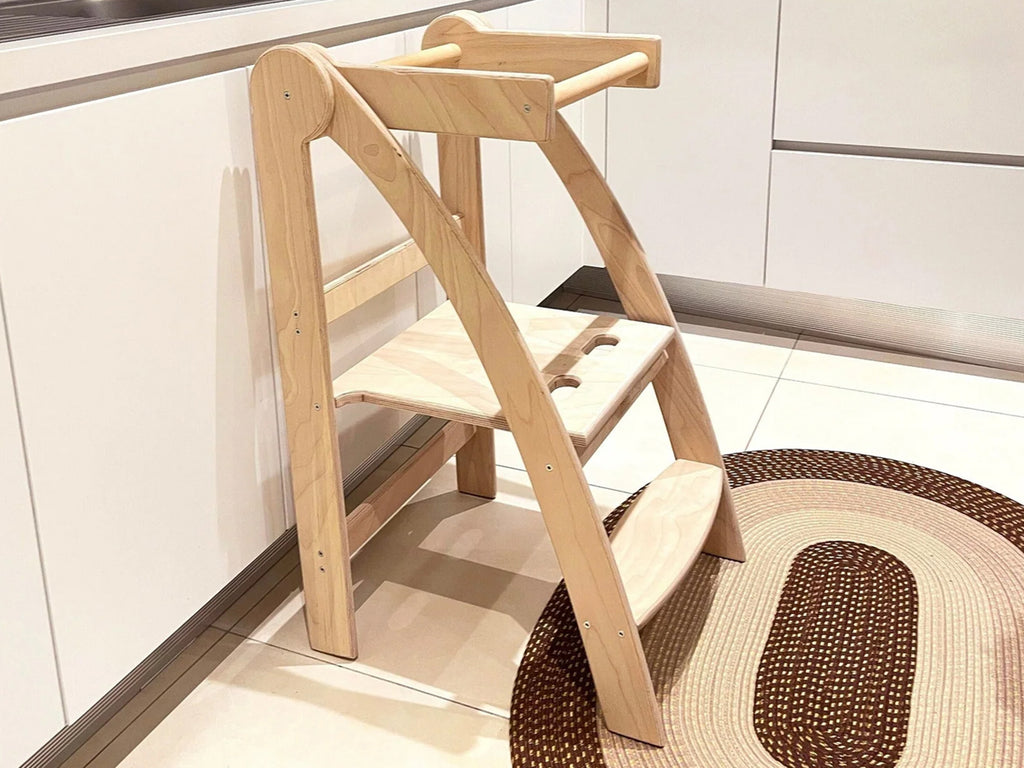 a wooden step stool in a kitchen next to a rug