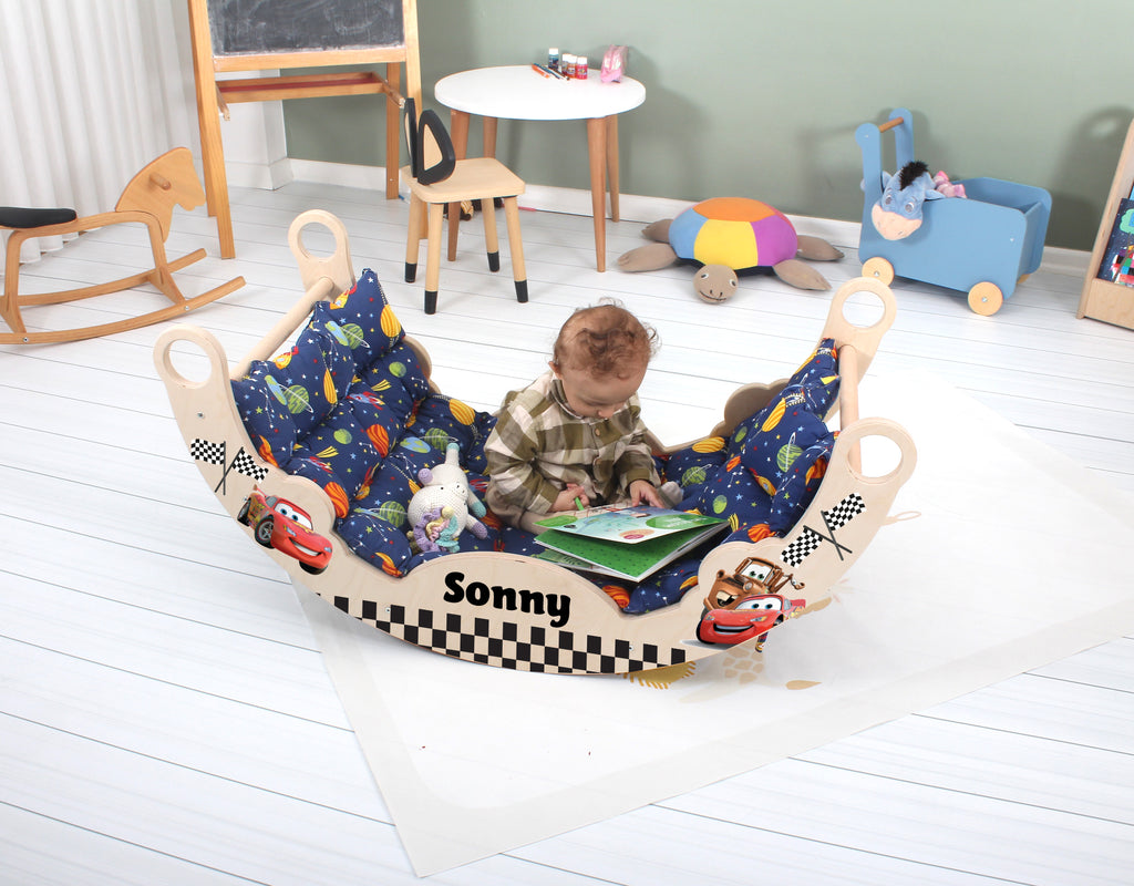 a baby sitting in a toy car reading a book