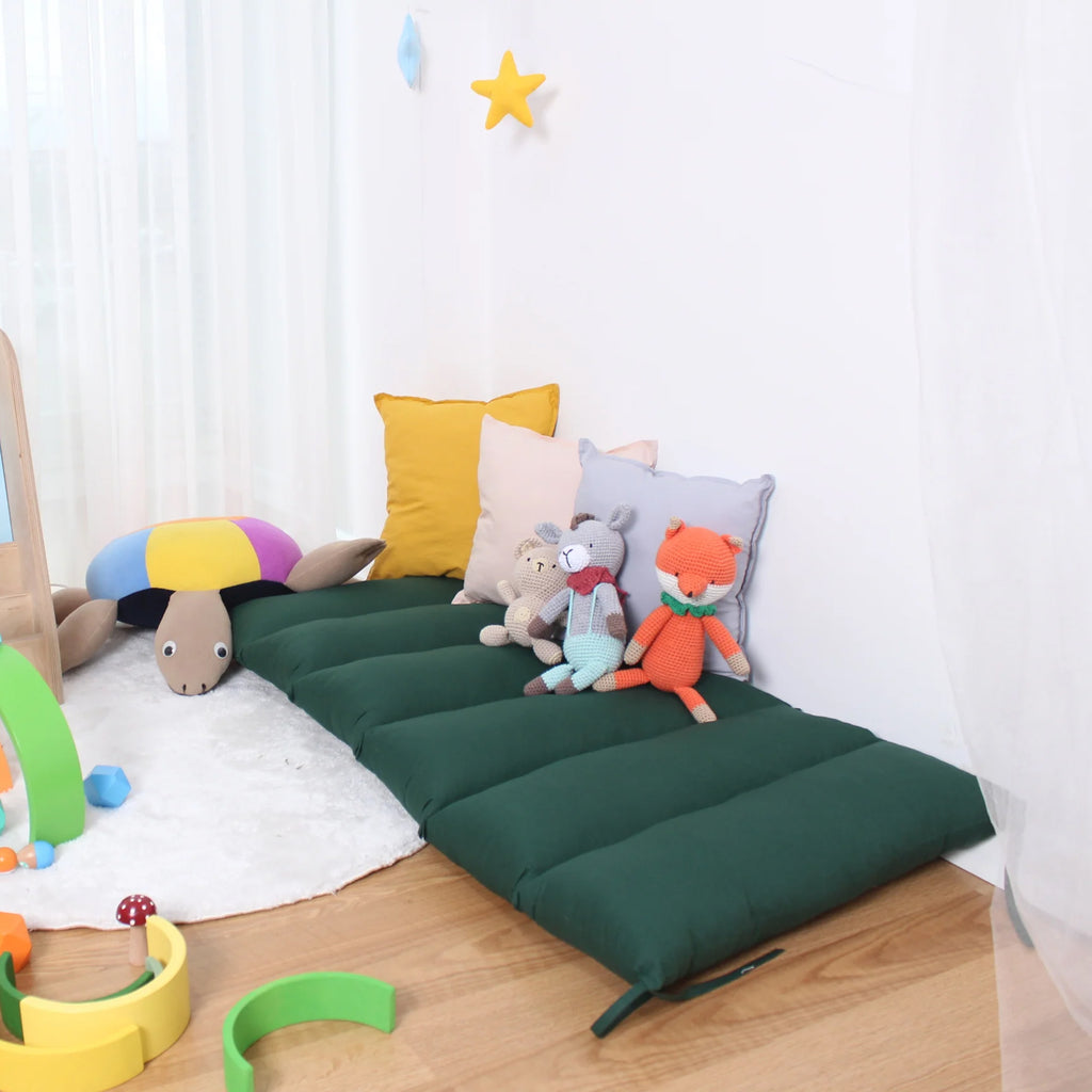 a child's room with a bed and toys on the floor