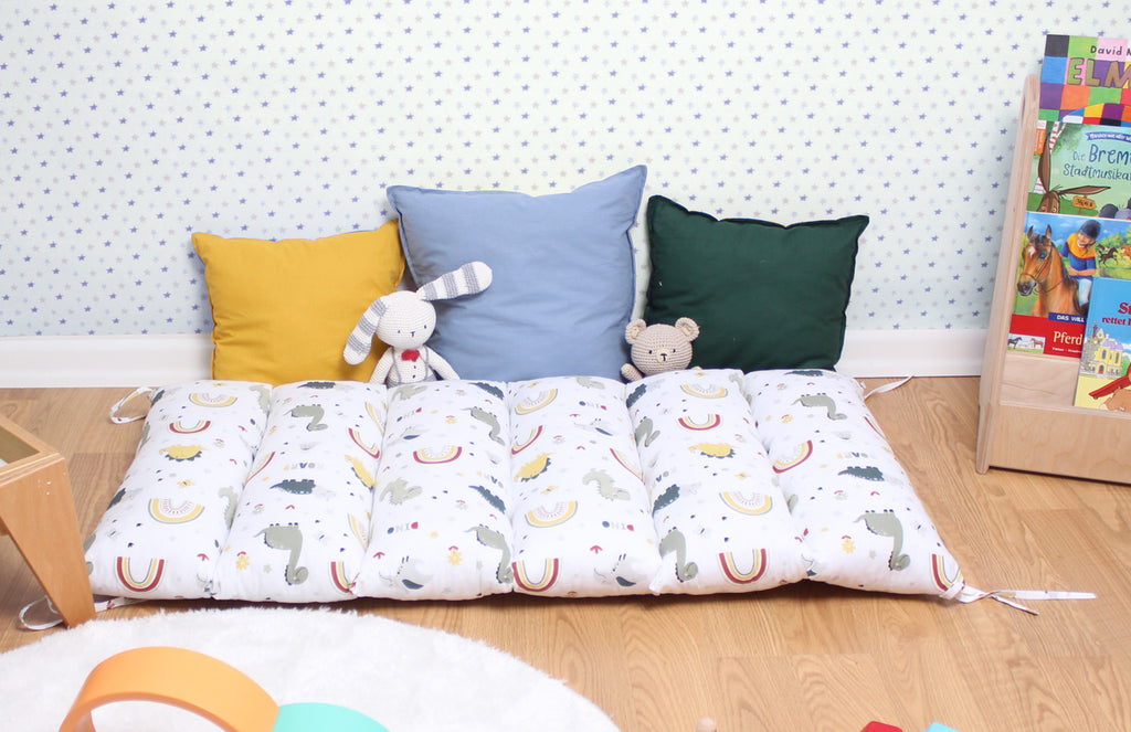 a child's bed with a stuffed animal on top of it