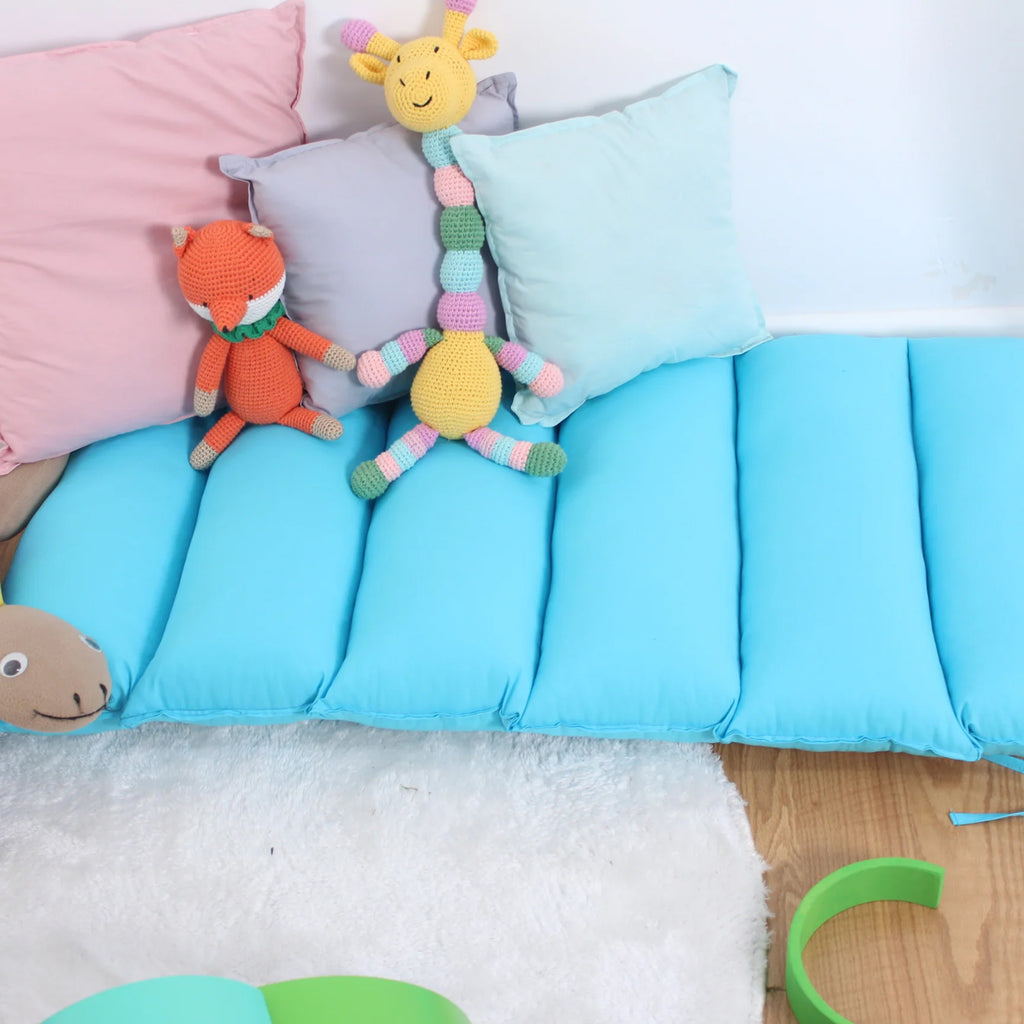 a child's bed with stuffed animals on top of it