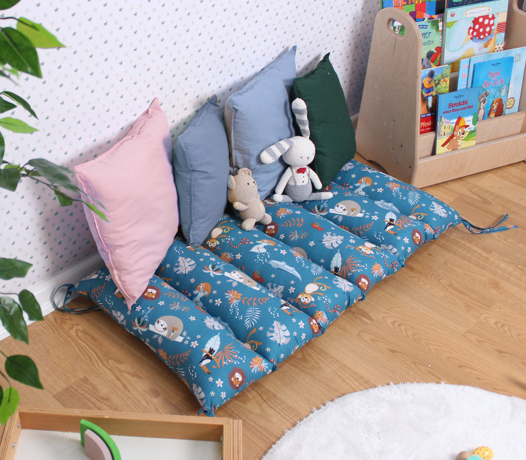 a child's play room with toys and pillows