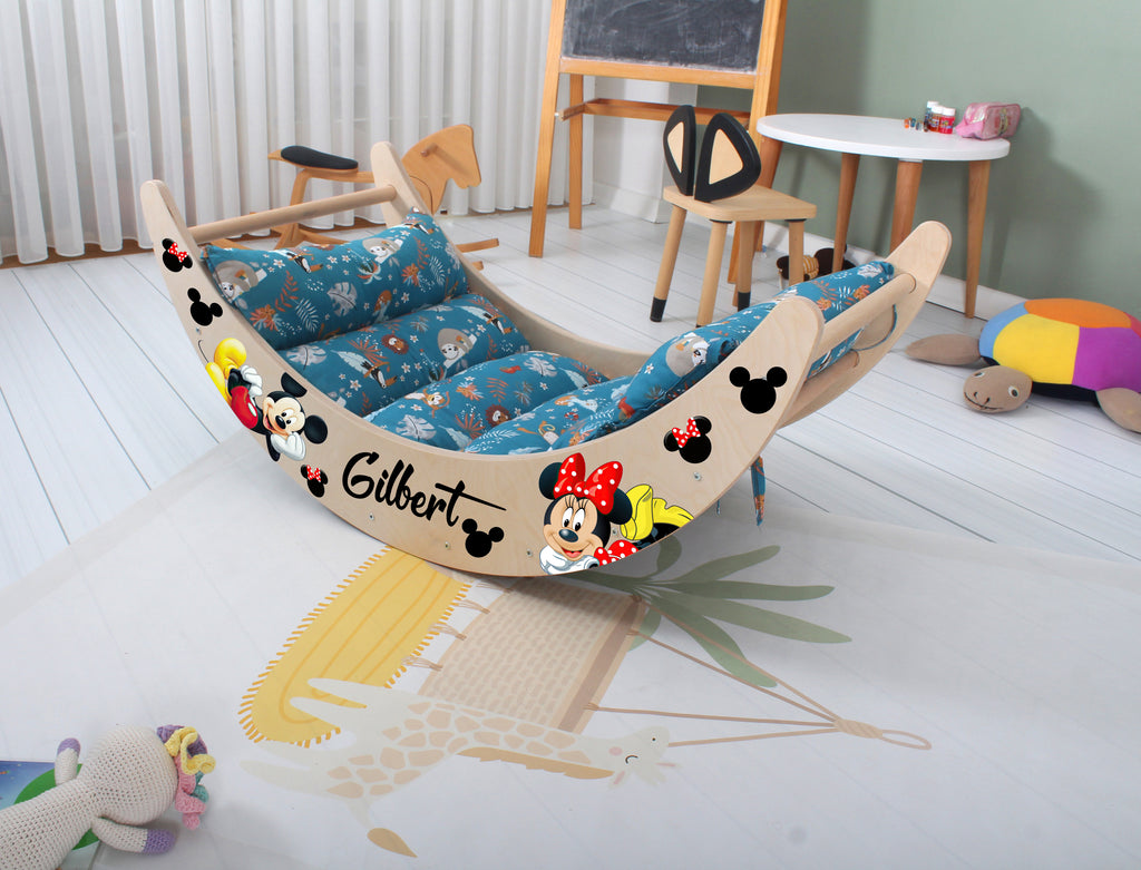 a child's bed with a mickey mouse theme