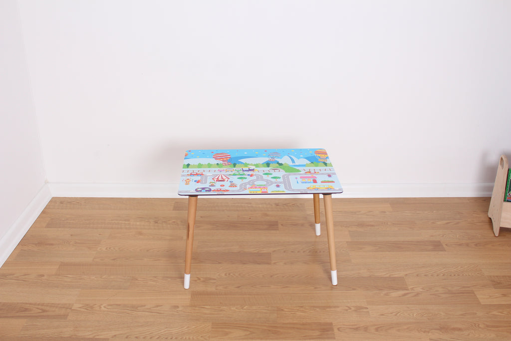 a small wooden table with a colorful cover on top of it