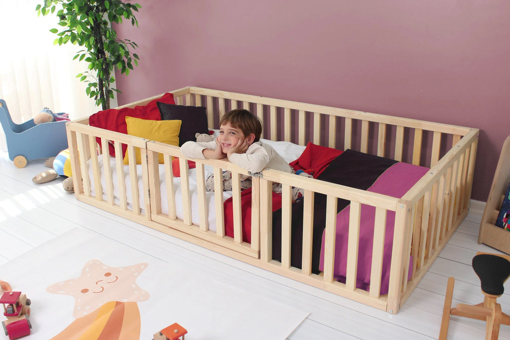 a little girl laying in a wooden crib