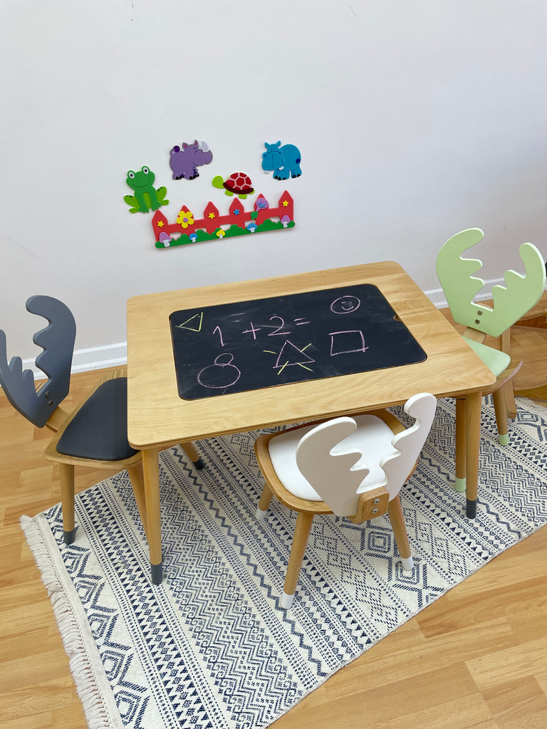 a child's play area with a chalkboard and toys