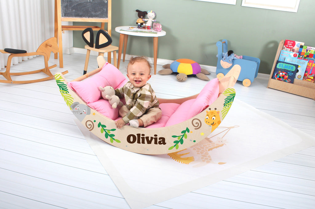 a baby sitting in a toy boat with a name on it