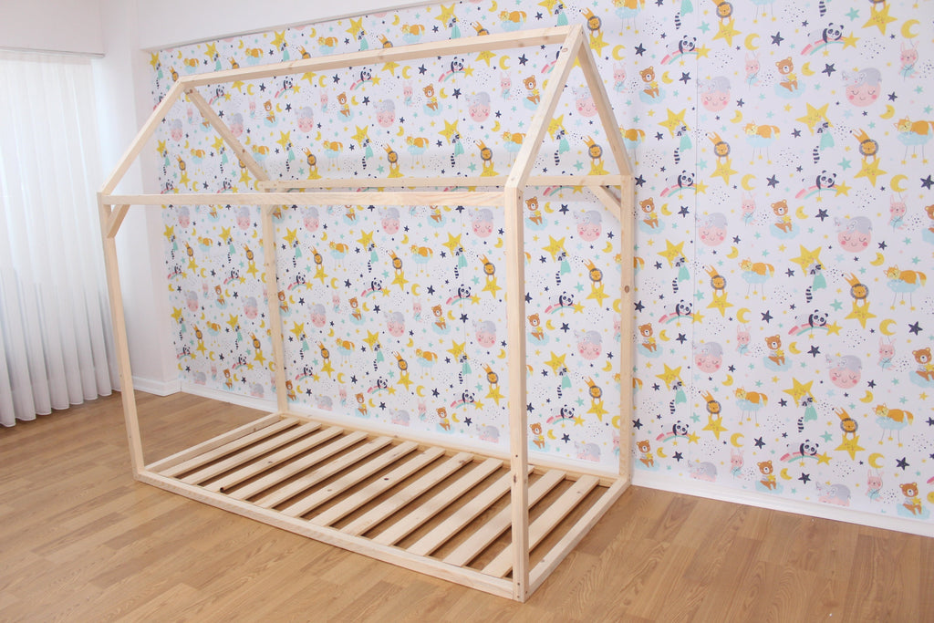 a wooden bed frame in front of a wallpapered wall